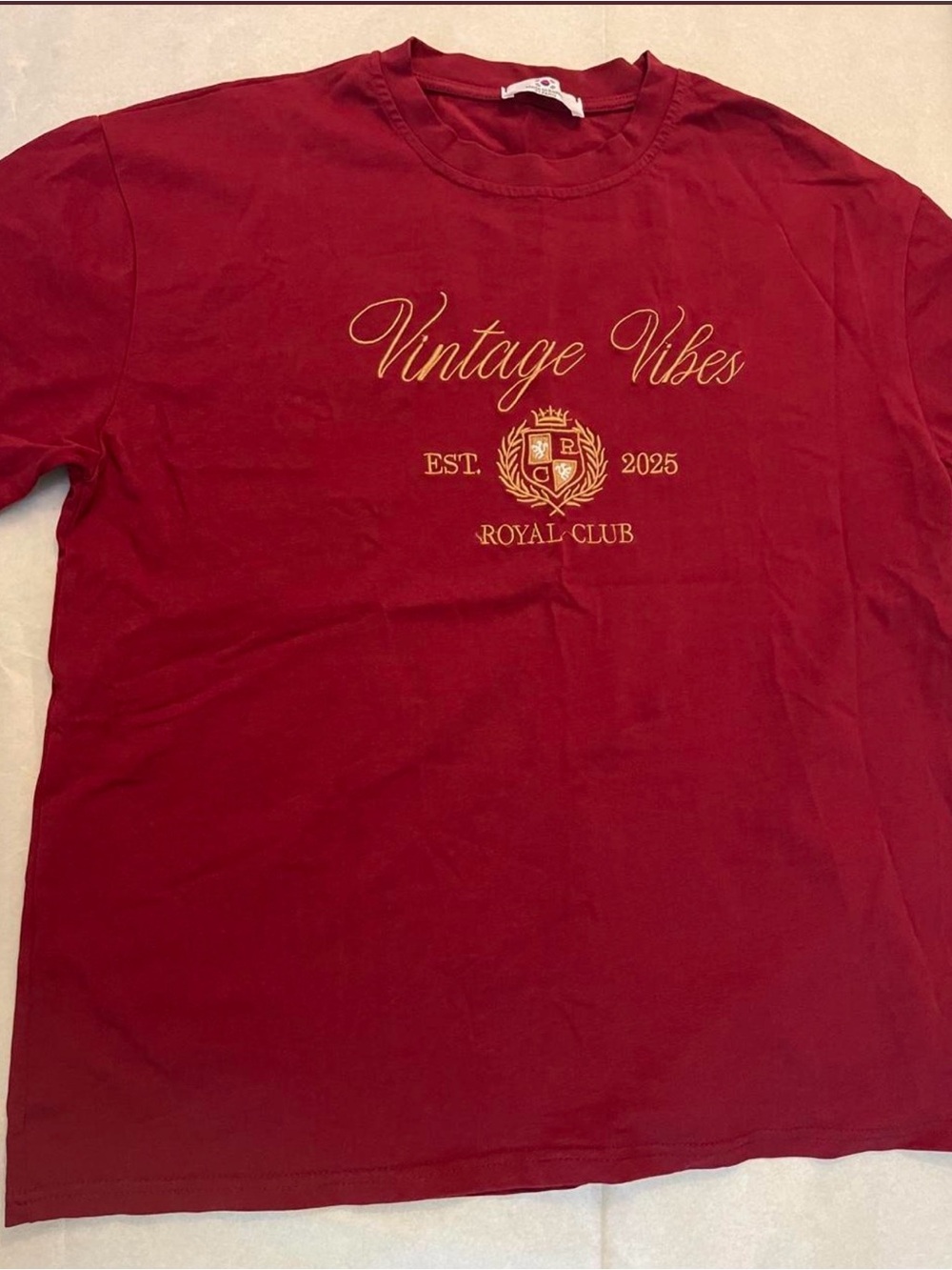 Burgundy vintage vibes tee with gold text reading 'Vintage Vibes', 'EST. 2025',
